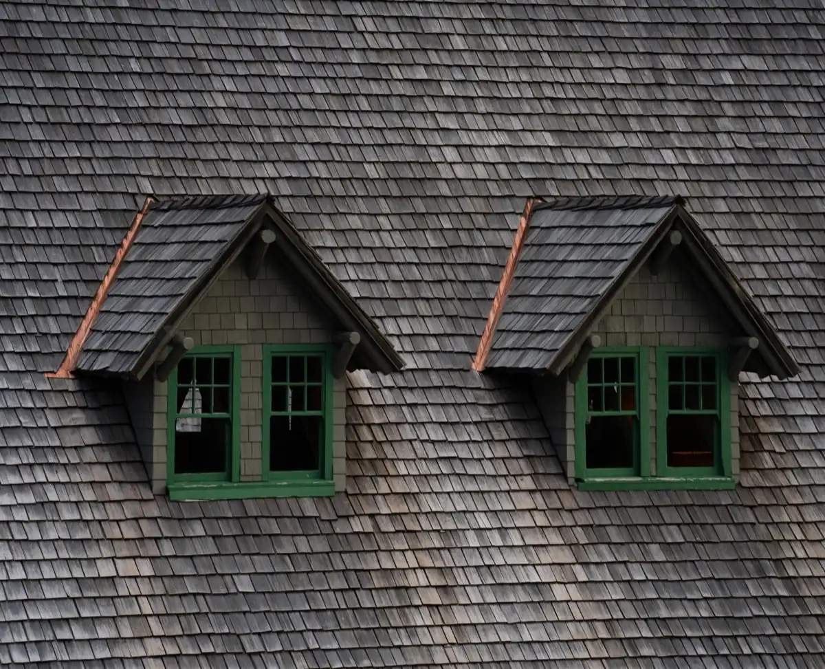 Dormers on a shingle roof in Blue Springs, MO, where step flashing and kickout flashing carry water past the walls